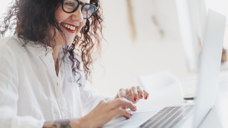 Smiling woman at computer.