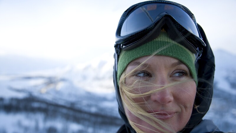 Woman on ski slope with ski goggles