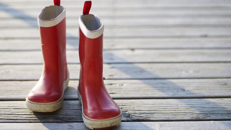 Red rubber boots on pier