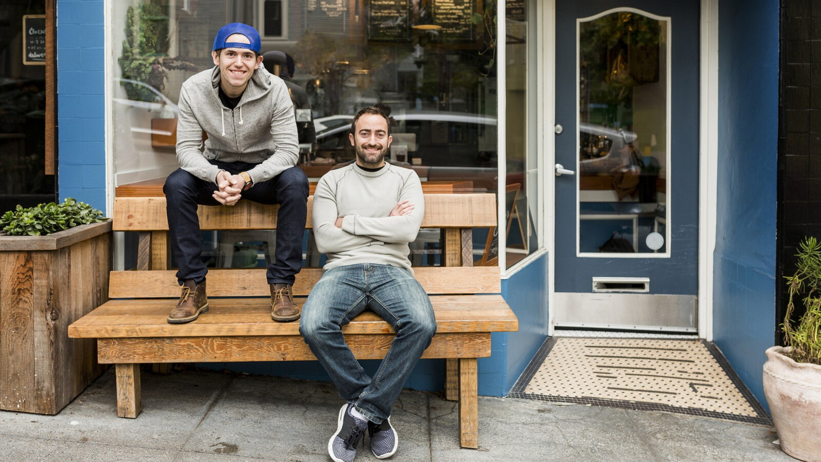 Two young men outside a restaurant